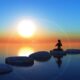 A person practicing meditation near a serene water body, embracing tranquility and inner peace