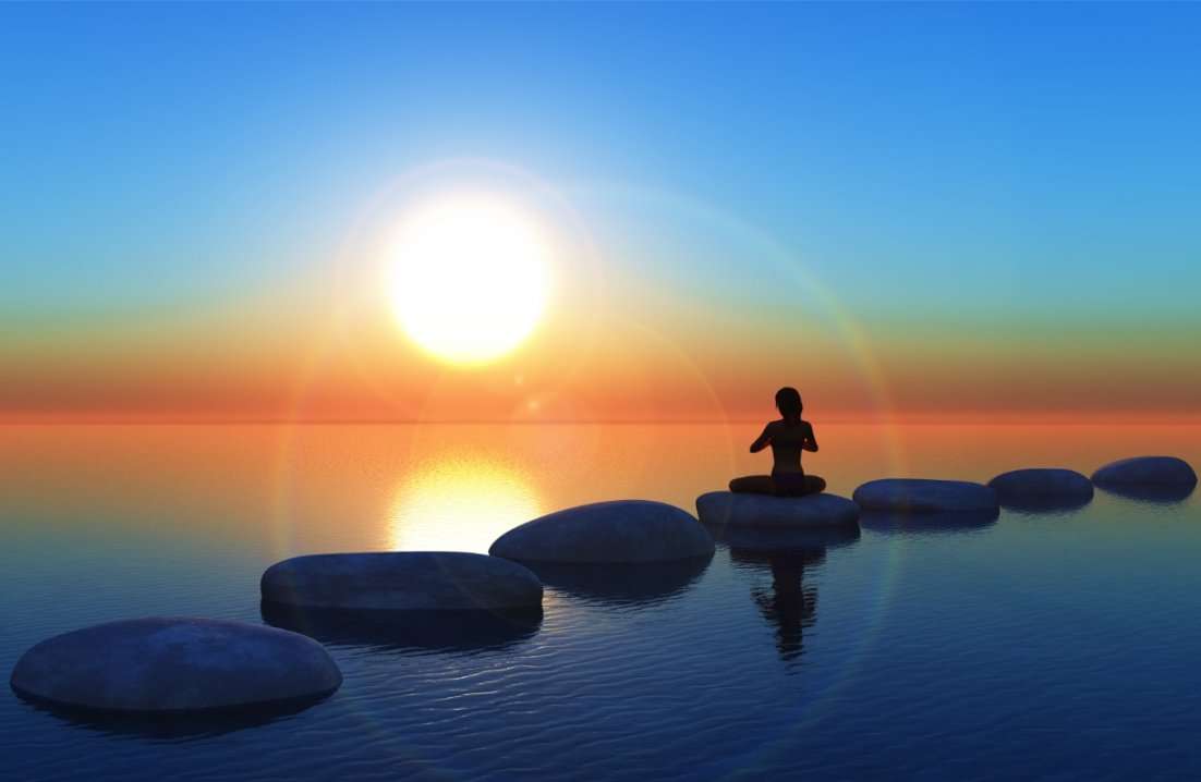 A person practicing meditation near a serene water body, embracing tranquility and inner peace